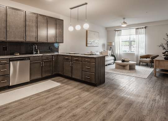 This modern kitchen boasts rich dark wood cabinets and a full suite of stainless steel appliances for convenient cooking.