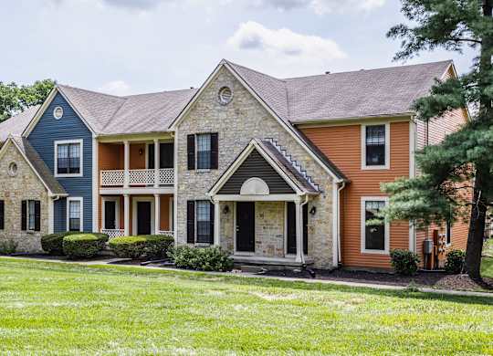 Exterior view of Fairway Lakes surrounded by trees and landscaped grass.