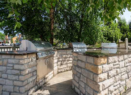 A stone wall with a metal grill on top.