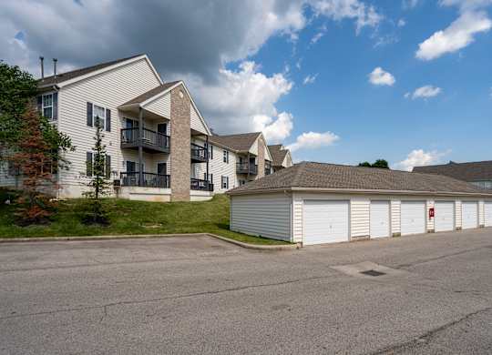 A parking lot with a building and a garage door.
