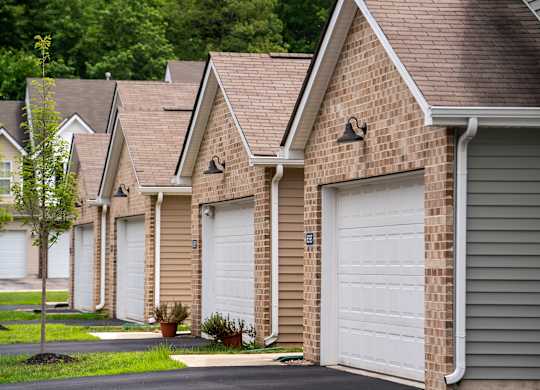A row of houses with white garage doors.