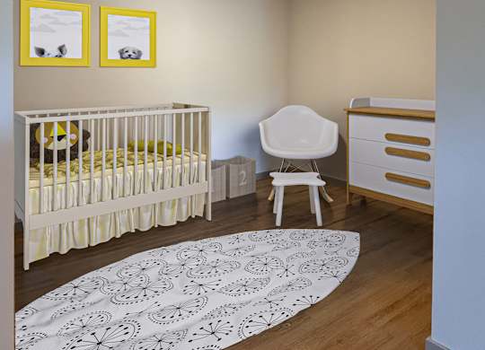 A baby room with a crib, chair, and pictures on the wall.