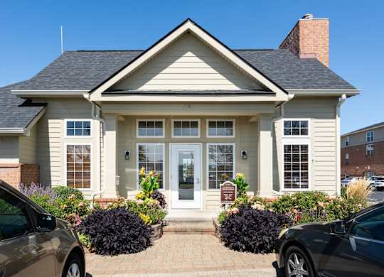 Residential home with parked cars in the driveway