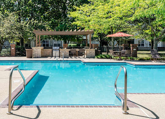 Glowing blue swimming pool at the Britton Woods apartment community