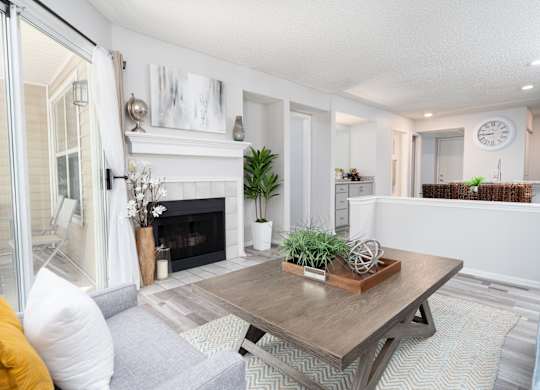 Oversized living room with a fireplace and wood-style flooring in a Britton Woods apartment in Dublin, Ohio