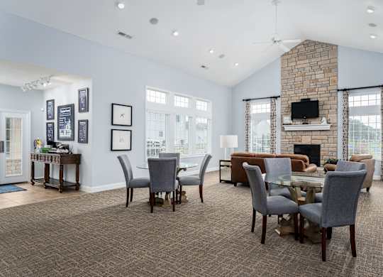 Living room at Carson Farms with a fireplace, dining table, and chairs—perfect for entertaining