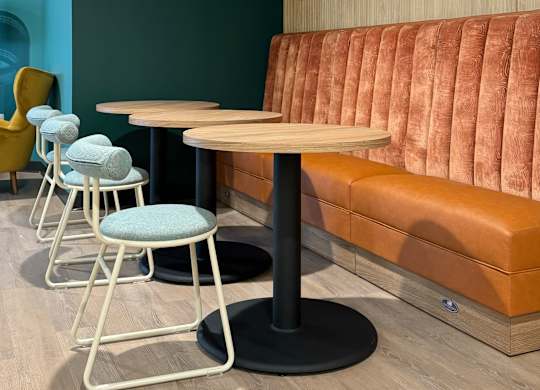 A comfortable seating area with a table, chairs, and a couch for lounging.