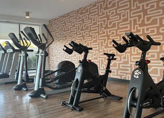 A state-of-the-art fitness center with multiple rooms and a variety of exercise equipment.