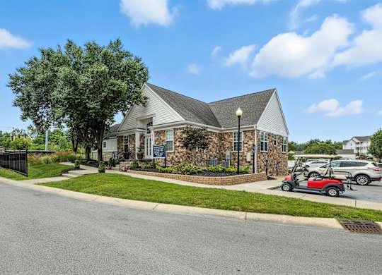 A house with a red golf cart in front of it.