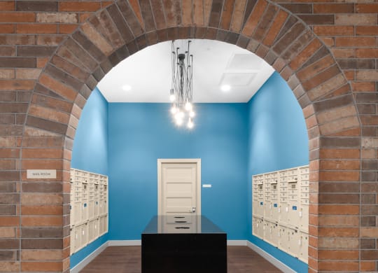 A private mail and delivery room with white lockers on a blue wall.