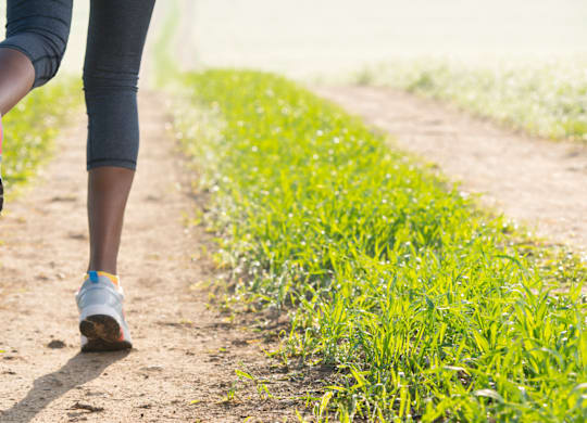 A person is running on a dirt path.