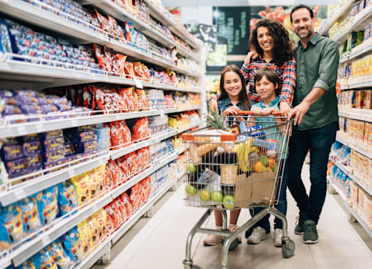A family of four is shopping in a grocery store.