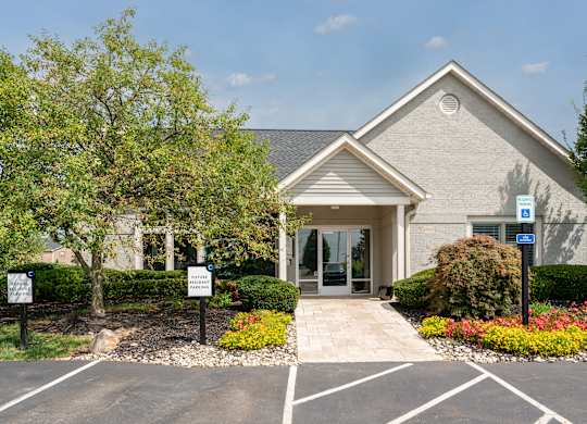 Clubhouse-style community building surrounded by manicured landscaping