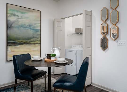 Dining nook with wooden table, two blue chairs, and nearby kitchen access at The Coleman in Canal Winchester, OH