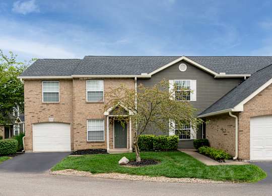 Single-family style residence at The Coleman with gray roof and clean exterior