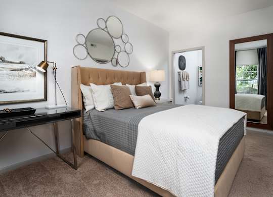 Cozy bedroom with desk setup and large bed, ideal for work-from-home living