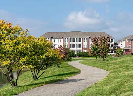 A pathway leads to a building with a grassy area on either side.