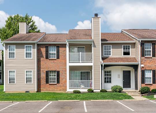 The Oaks exterior featuring apartment balconies and landscaped grounds.