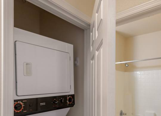 A white oven and dishwasher are built into a cabinet in a kitchen.