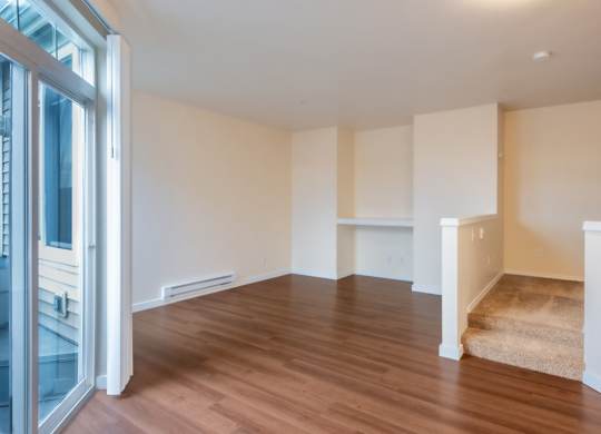 A room with wooden floors and white walls.