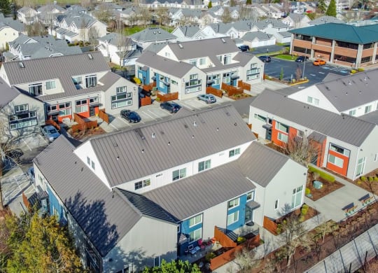 arial view of a neighborhood of houses with roofs