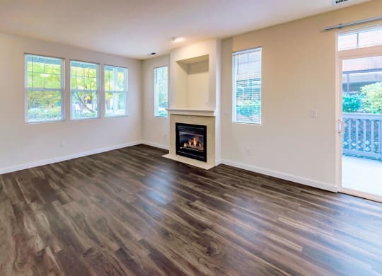 a living room with a fireplace and wooden floors