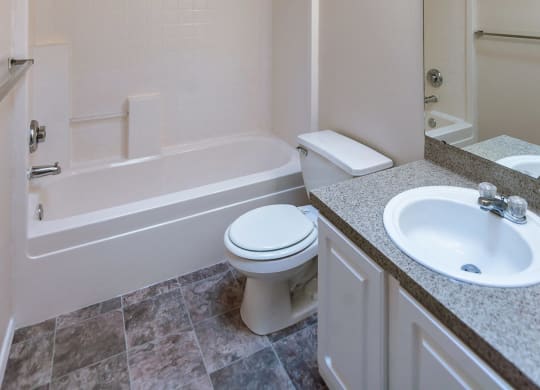 a bathroom with a sink toilet and a bath tub