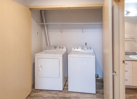 a room with two washes and a dryer in it