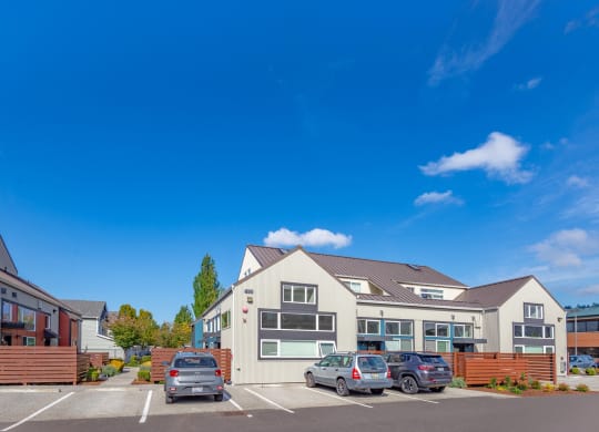 a parking lot with cars in front of a house
