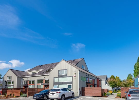 the exterior of a house with cars parked in front of it