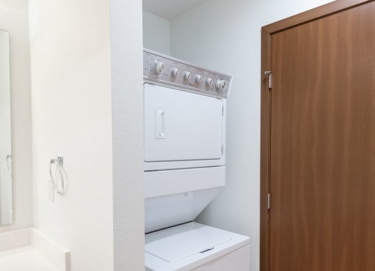 a bathroom with a washer and dryer in a closet
