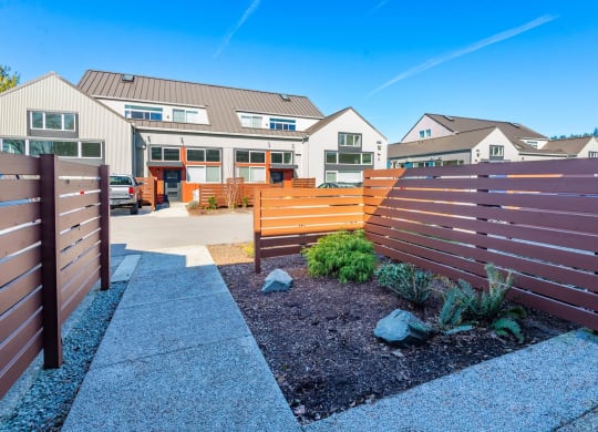 a wooden fence in front of a house