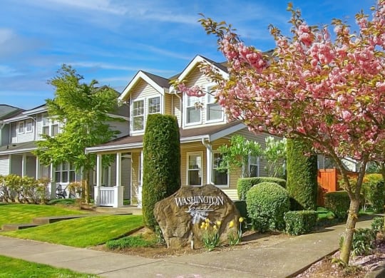 a large house with a sign in front of it