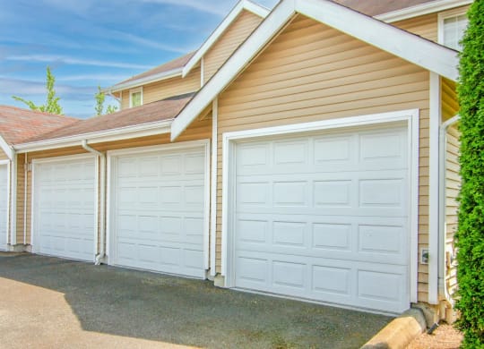 a row of garage doors on the side of a house