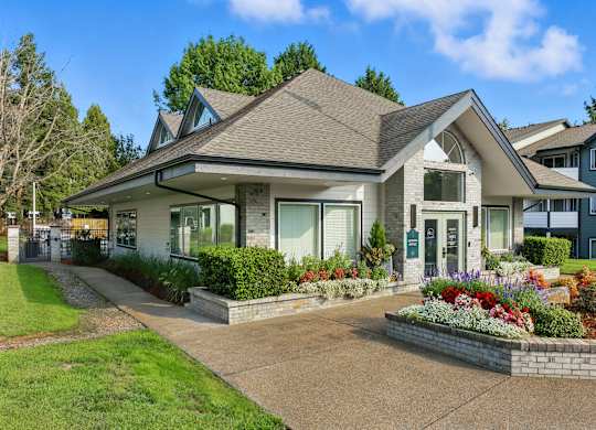 A house with a grey roof and a white front porch.