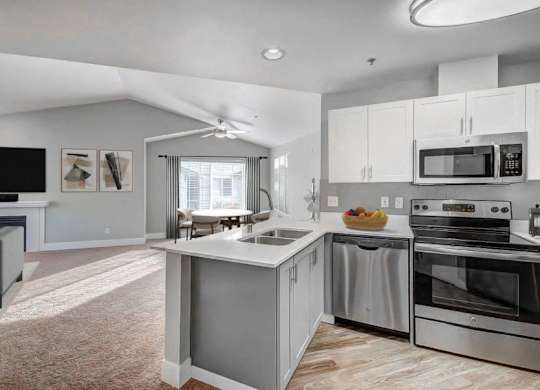 Stainless-Steel Appliances with Quartz Countertops and White Cabinets at Clock Tower Village, DuPont, WA