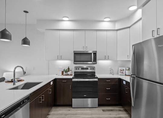 a kitchen with stainless steel appliances and white cabinets
