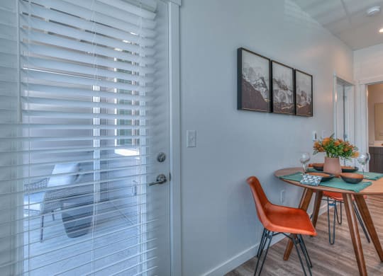 a dining room with a table and chairs next to a glass door