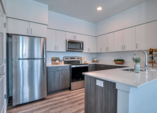a kitchen with stainless steel appliances and white cabinets