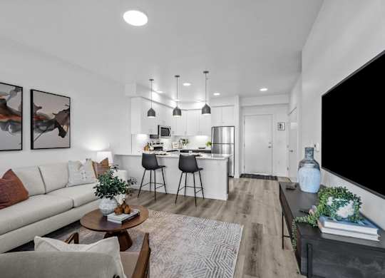 an open living room and kitchen with a couch and a table