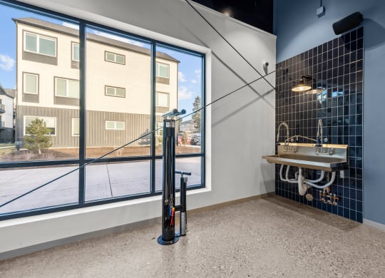 a bathroom with a sink and a window with a street view