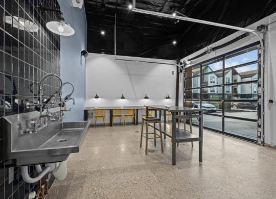 a tasting room with a table and chairs and a large window