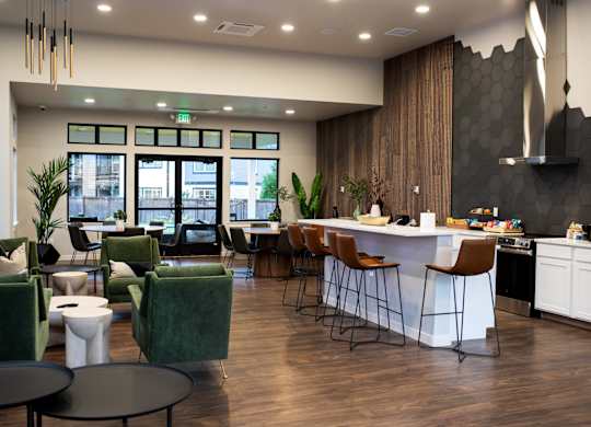 A modern living room with a kitchen area in the background.