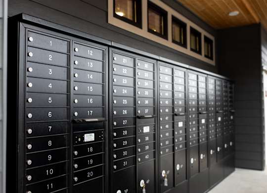 A set of black mailboxes with numbers 1 to 31 on them.