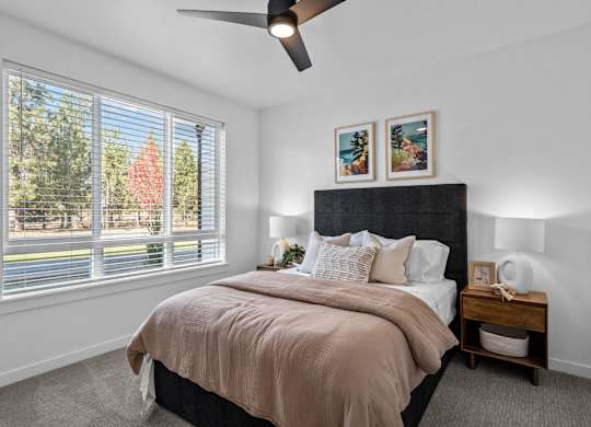 a bedroom with a large window and a bed