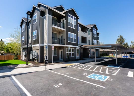 an empty parking lot in front of an apartment building