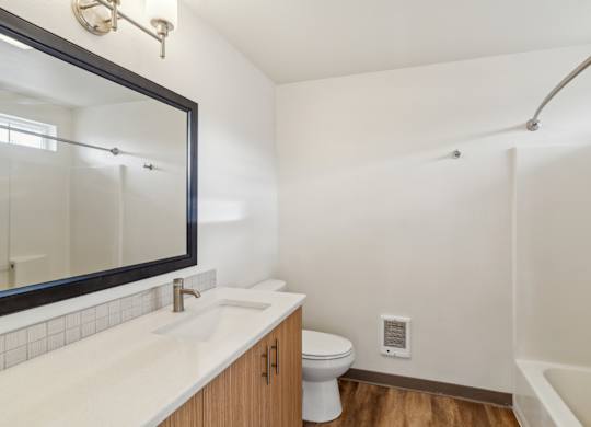 A white sink with a mirror above it in a bathroom.