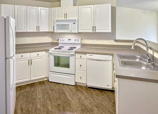 kitchen with white appliances at Clock Tower Village, Washington, 98327
