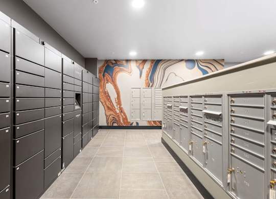 the locker room at the gym has lockers and a mural