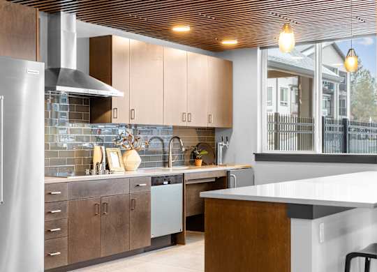 A modern kitchen with wooden cabinets and a white countertop.